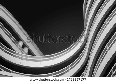 Abstract bottom up architectural view on modern residential building with curved walls and balconies, black and white high contrast, Abu Dhabi