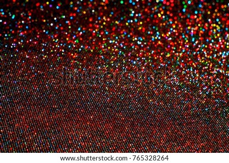 Abstract bright colored bokeh background. Lurex fabric. The small depth of field. 
