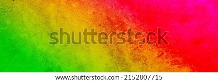   Abstract bright green yellow orange red background. Color gradient. Mix. Colorful. Emty space for design. Toned concrete wall. Rough. Web banner. Wide. Panoramic.                             