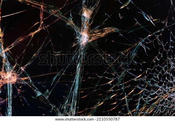 Abstract broken glass in\
a car windshield