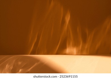 Abstract brown background with empty table for product presentation with natural light reflections like painted light or fire and shadows on blurry wall. Autumn background.


