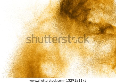Abstract brown dust explosion on  white background. Brown powder splattered on background.