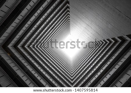 Abstract building facade concrete void or tunnel with natural light in the end in twist view/ architecture design / abstract concept / background texture