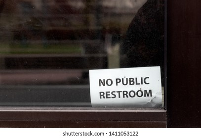 Abstract Building Window With No Public Restroom Sign In Daylight