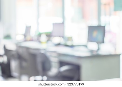 Abstract Business Blurred In The Workplace Or Work Space Of Table Work In Office With Computer Or Shallow Depth Of Focus As Corporate Interior Background.
