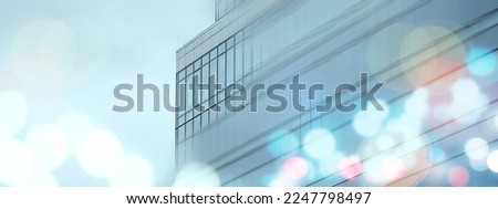 Abstract business modern city urban futuristic architecture background, motion blur, reflection in glass of high rise skyscraper facade, toned blue picture with bokeh. Real estate concept.