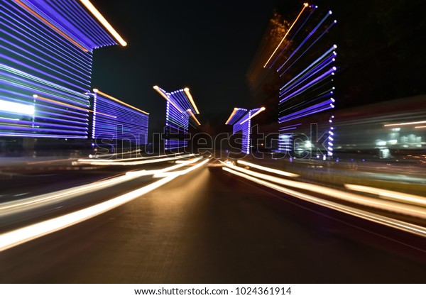 Abstract car trail on road. Abstract image of\
night traffic light on\
street.\
