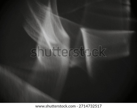 Abstract caustic light patterns created by refraction and reflection on a transparent surface. Can be used as overlay elements for design projects. 