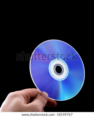 abstract cd dvd blue-ray disk in hand isolated on black