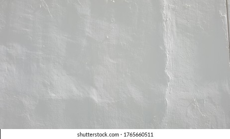 Abstract Of The Cement Wall Painted In White. It Looks Like A Slightly Wrinkled Paper.