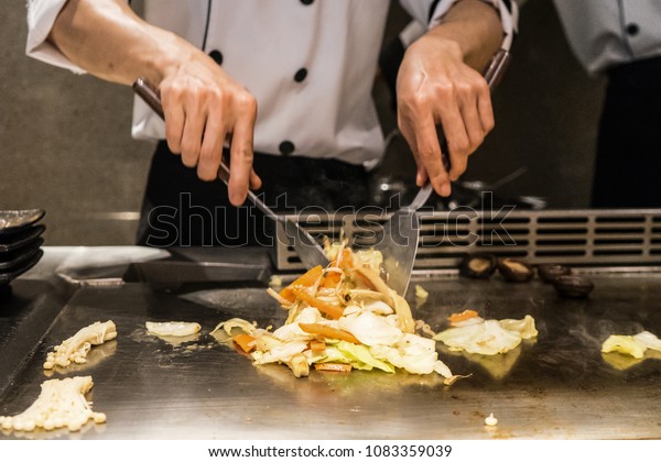 Abstract Chef is cooking Japanese style at\
the restaurant.
