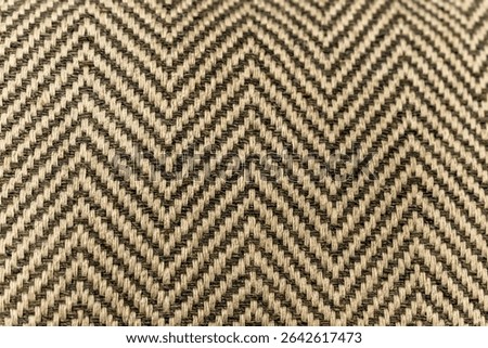 Abstract chevron pattern as background. tribal geometric chevron pattern beige fabric. Selective focus close up. Herringbone pattern backdrop. diagonal lines and shapes forming a geometric pattern bg