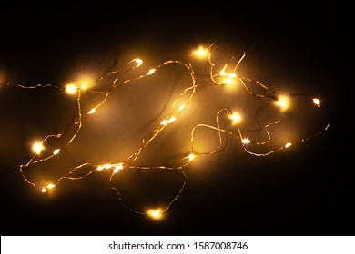 Abstract Christmas Led Lights On Black Background. Blurred Glowing Light Bulb Garland, Black Layer For Screen Mode Overlays To Light Up The Bulbs. Festive Concept