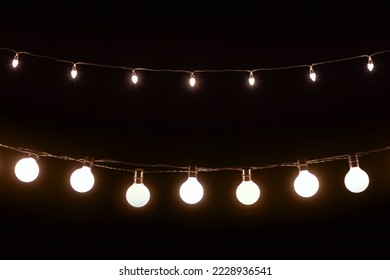 Abstract christmas led lights on dark background, electric garland on black background, mock-up for design, warm light - Powered by Shutterstock