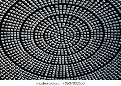 Abstract circular glass ceiling featuring intricate radial patterns and geometric symmetry.