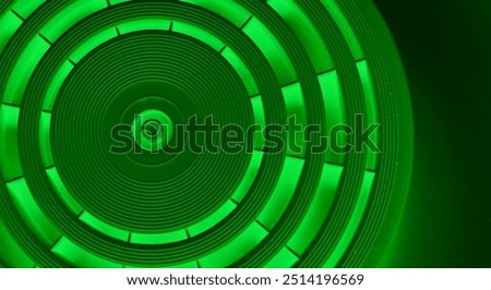 Abstract Circular Pattern With Green Backlit Of Same Segments On Dark Green Backdrop
