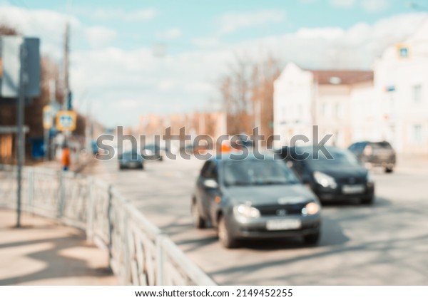 Abstract city life environment.\
Defocus city road and buildings, cars on sunny day\
outdoors.