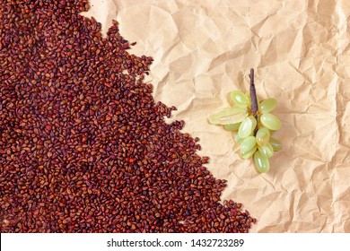 Abstract Close Up Texture With Dried Grape Seeds And Vintage Paper With Decorative Bunch Of Grapes