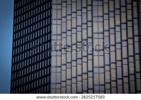 Abstract close view of skyscraper windows and office tower facades in a North American downtown, showing glass patterns, corporate architecture and a business background.