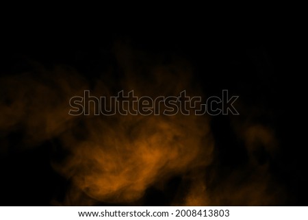 Abstract close-up of brown mist or steam smoke. isolated on black background in mysterious darkness