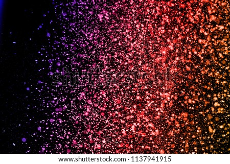 Abstract closeup dust on backdrop.Colored powder explosion.Colorful explode. Paint holi