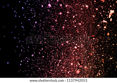 Abstract closeup dust on backdrop.Colored powder explosion.Colorful explode. Paint holi