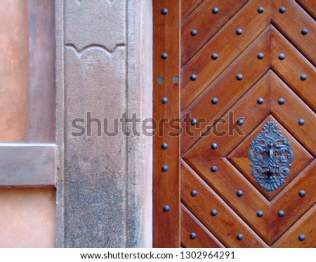 Abstract closeup of elaborated studded wooden door and weathered stucco wall in Prague, Czech Republic Imagine de stoc © 