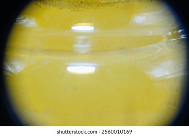 Abstract close-up of liquid in a container with markings. Reflections and textures create a unique, scientific or industrial feel. - Powered by Shutterstock