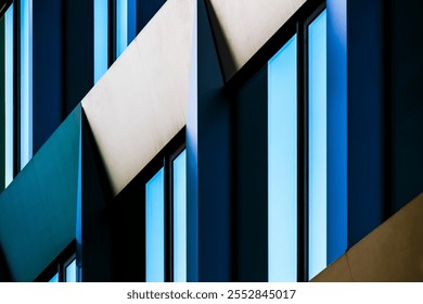 Abstract Close-Up of Modern Building Facade with Angular Patterns and Reflective Blue Windows - Powered by Shutterstock - Get 15% off with code: PIKWIZARD15