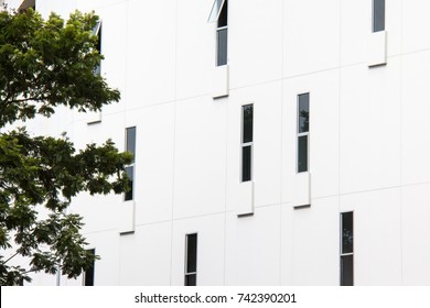 Abstract close-up view of the random narrow window with concrete wall on facade.