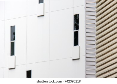 Abstract close-up view of the random narrow window with concrete wall on facade.