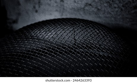 Abstract Close-Up of Woven Metal Mesh in Dark Lighting, Close-up of woven metal mesh captured in dark lighting, showcasing the intricate patterns and textures - Powered by Shutterstock