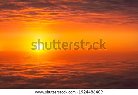 Abstract clouds. Fantasy bright orange sunset clouds with sun rays
