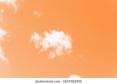 Abstract clouds in an orange sky. Light brown aesthetic. Monochrome cloudscape concept