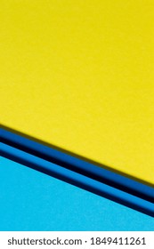 Abstract color papers geometry flat lay composition background with blue and yellow tones