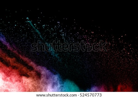 abstract color powder splatted on black background.Freeze motion of white powder exploding throwing ,painting powder in multicolored.