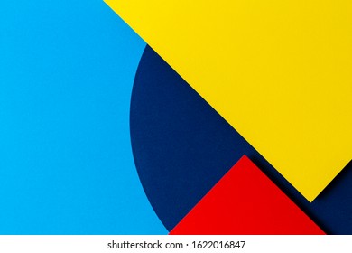 Abstract colored paper texture background. Minimal geometric shapes and lines in light blue, navy, red and yellow colours - Shutterstock ID 1622016847
