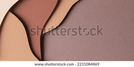 Abstract colored paper texture background. Minimal paper cut style composition with layers of geometric shapes and lines in shades of beige and brown colors. Top view, copy space