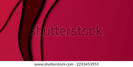 Abstract colored paper texture background. Minimal paper cut style composition with layers of geometric shapes and lines in viva magenta colors. Top view