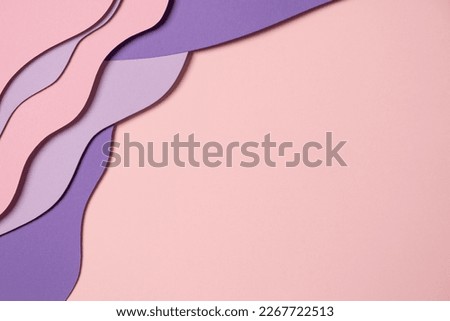 Abstract colored paper texture background. Minimal paper cut composition with layers of geometric shapes and lines in pastel pink and violet purple colors. Top view, copy space
