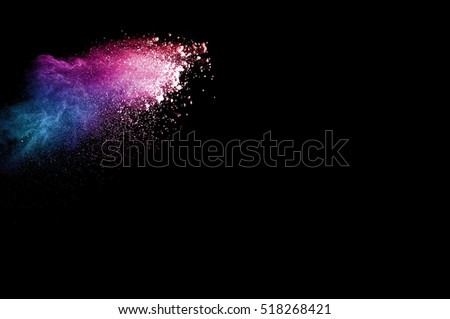 Abstract colored powder on a black background. Frozen abstract movement of dust explosion multiple colors on a black background. Stop the movement of multicolored powder on a dark background.
