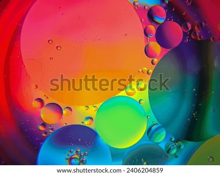 Abstract Colorful Food Oil Drops Bubbles and spheres Flowing on Water Surface Macro Photography. Abstrack background.