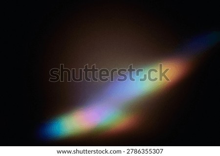 Abstract colorful rainbow light refracting and scattering on dark background