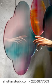 Abstract colourful cloud pattern light refraction with hand and white background. Colourful light and shadow light effect stock photo
