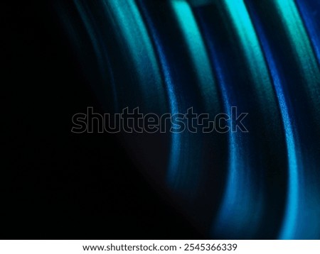 Abstract colourful light pattern with layered rings in blue and green hues. Modern and futuristic design with vibrant gradient reflections and soft texture.