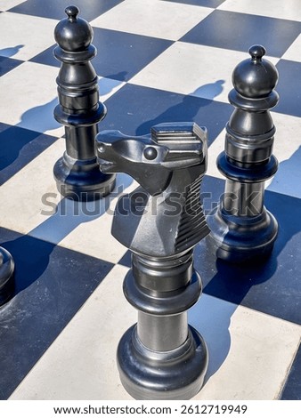 Abstract composition of chess pieces casting long shadows, metaphor for planning and foresight