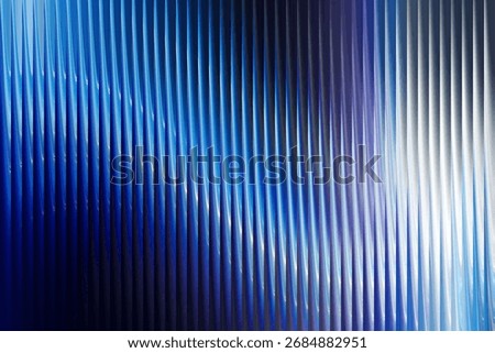 An abstract composition featuring a dynamic interplay of vibrant blue and purple hues. Vertical lines and reflections create a sense of depth and movement, ideal for modern designs.