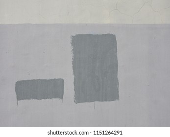 
Abstract composition in the form of gray rectangles, depicted on a light gray wall. Background structure.					
