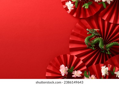 Abstract composition with paper fans, dragon, sakura on red backdrop, celebrating Chinese New Year 2024. Asian art and culture in a festive design. - Powered by Shutterstock