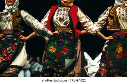 Abstract composition showing three women dressed in Serbian traditional clothe dancing in folklore. 